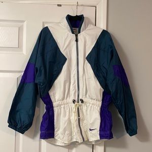 Size M (10-12) Women’s Nike wind breaker suit. Purple,green and white.